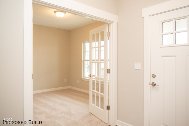 doorway with light colored carpet