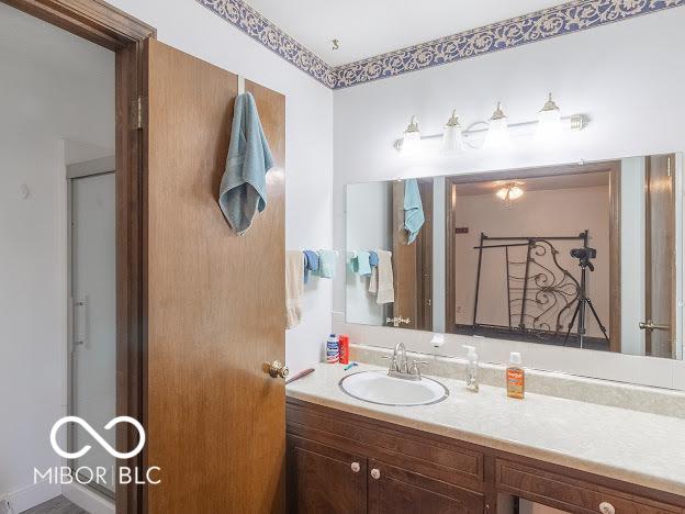 bathroom featuring vanity and an enclosed shower