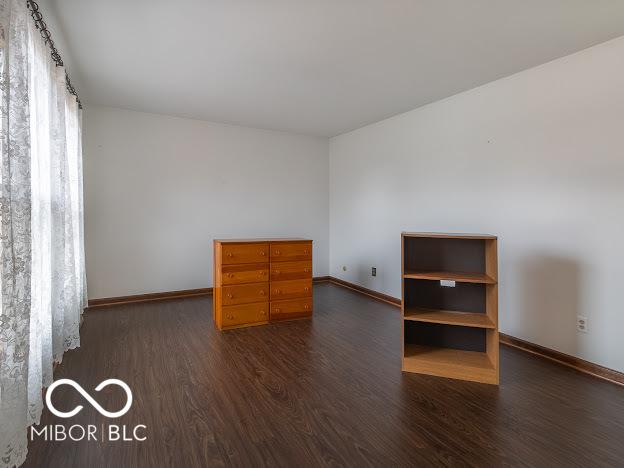 unfurnished room with dark wood-type flooring