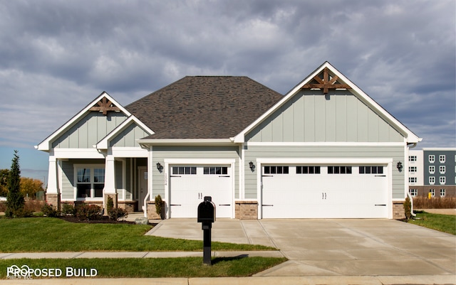 craftsman inspired home with a front yard and a garage