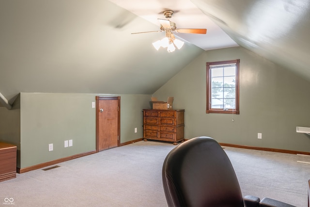 carpeted office space with ceiling fan and lofted ceiling