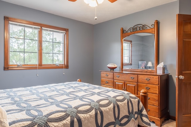 bedroom with ceiling fan and light colored carpet