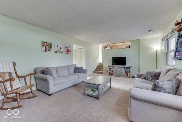 living room with light colored carpet and a textured ceiling