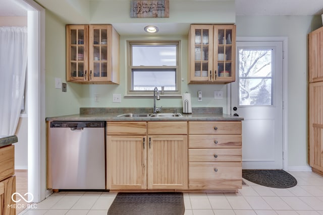 kitchen featuring light tile patterned flooring, light brown cabinetry, dishwasher, and sink