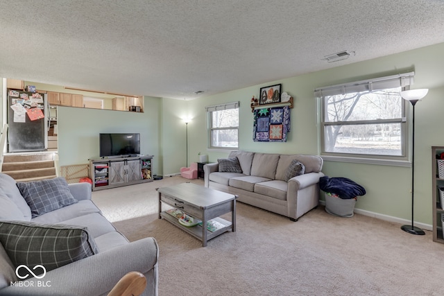 living room with light carpet and a textured ceiling