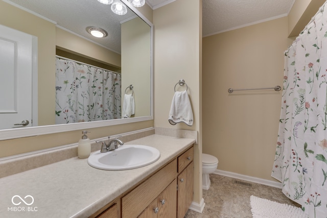 bathroom featuring vanity, crown molding, toilet, and a textured ceiling