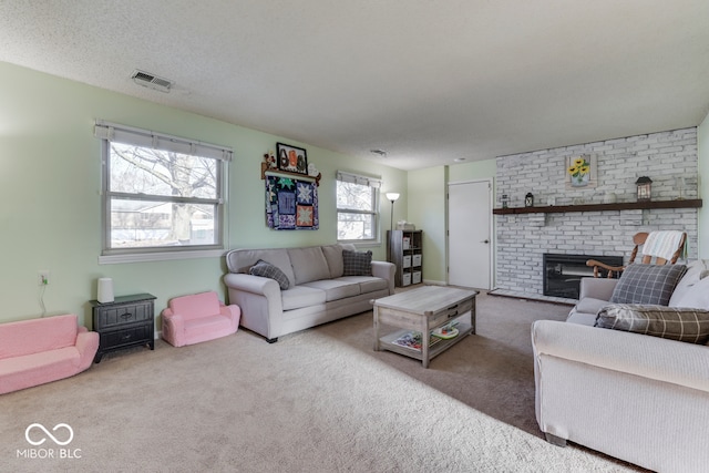 carpeted living room with a brick fireplace and a textured ceiling