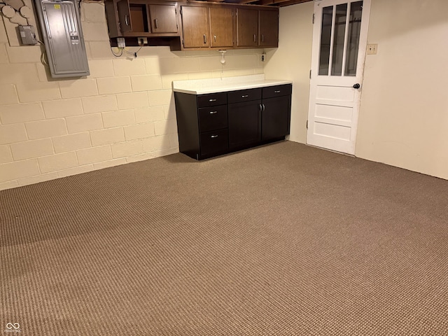 kitchen featuring carpet, electric panel, and dark brown cabinetry