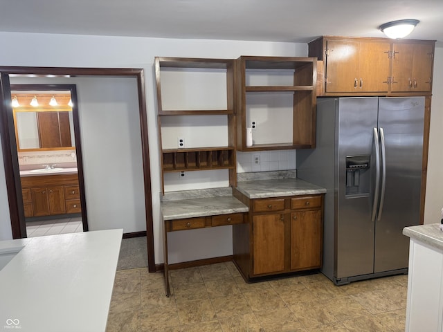 kitchen with sink, stainless steel fridge, and decorative backsplash