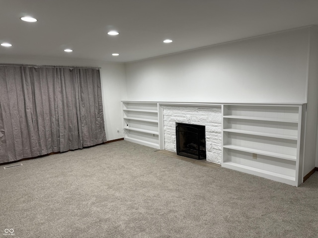 unfurnished living room with a fireplace and carpet floors