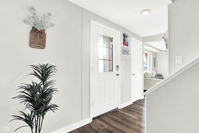 entryway with a textured ceiling and dark hardwood / wood-style floors