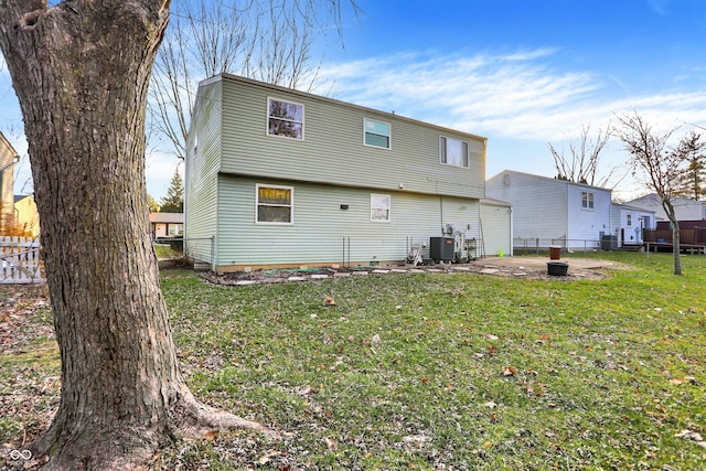 rear view of property with cooling unit, a patio area, and a yard