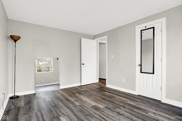 spare room with dark hardwood / wood-style floors