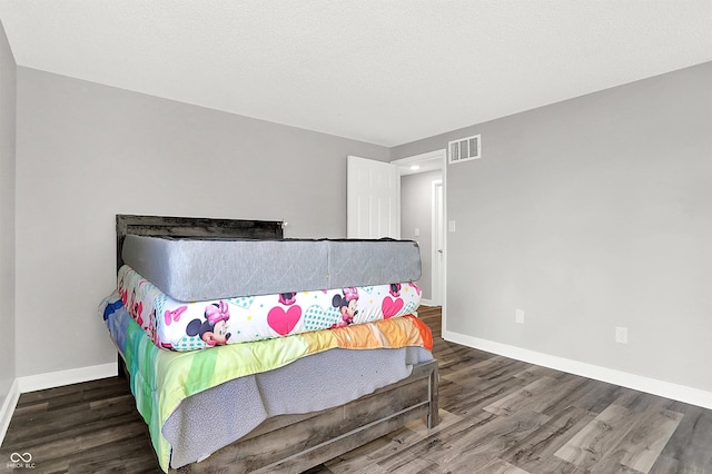 bedroom featuring dark hardwood / wood-style flooring