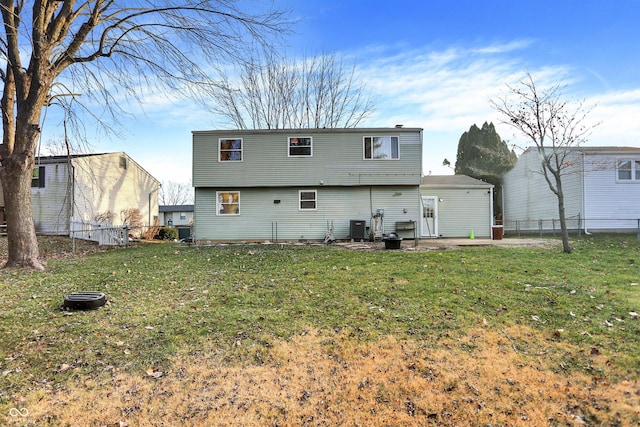 rear view of property with central AC, a yard, and a patio