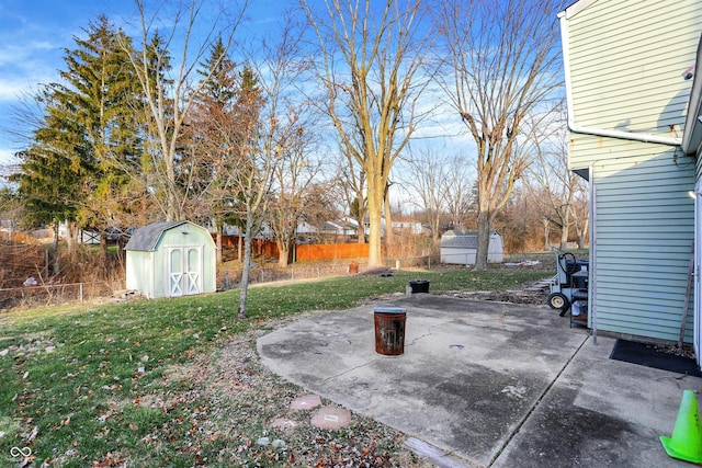 view of yard featuring a storage shed and a patio area