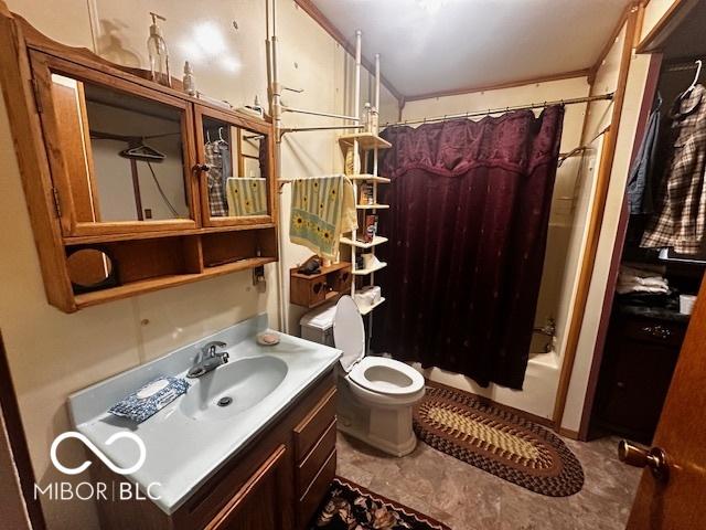 full bathroom with shower / bath combo, vanity, and toilet