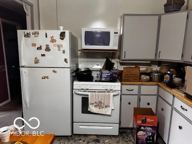 kitchen with white appliances and white cabinetry