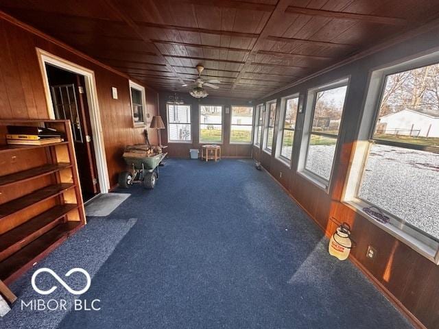 sunroom / solarium with ceiling fan and wooden ceiling