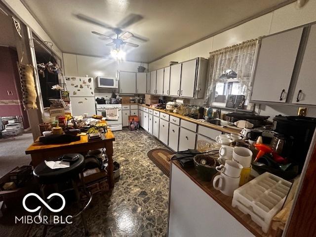 kitchen with white cabinets, ceiling fan, white appliances, and sink