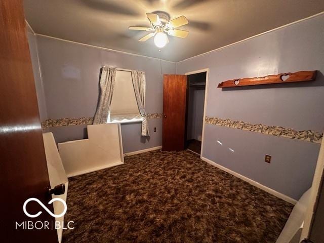 unfurnished bedroom featuring carpet and ceiling fan