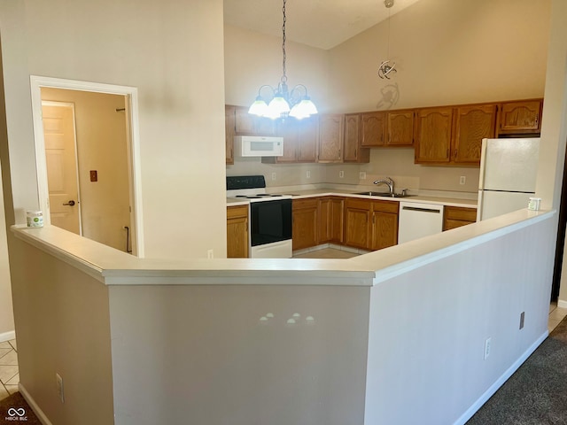 kitchen with sink, a chandelier, high vaulted ceiling, pendant lighting, and white appliances