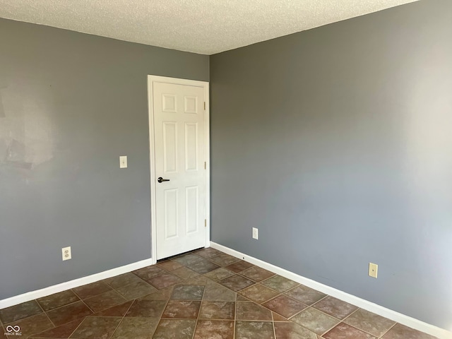 empty room featuring a textured ceiling