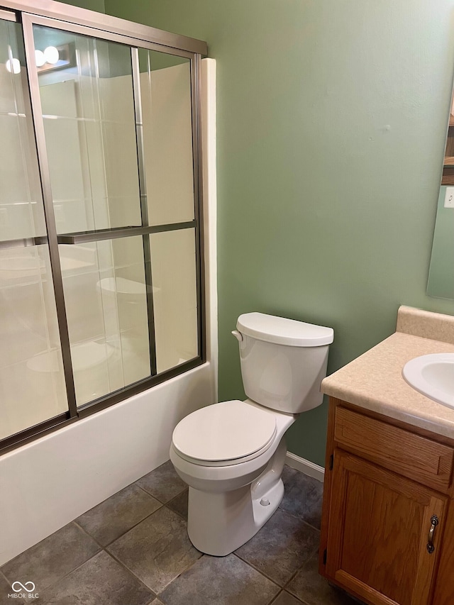 full bathroom featuring enclosed tub / shower combo, vanity, and toilet