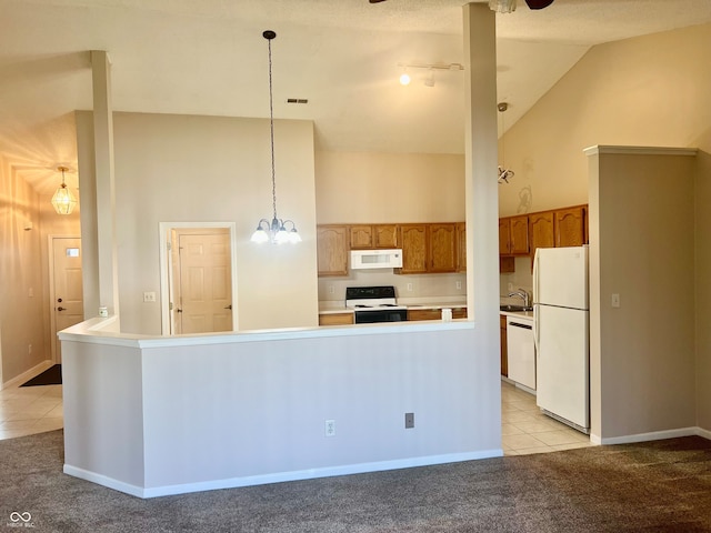 kitchen with light tile patterned flooring, sink, a chandelier, hanging light fixtures, and white appliances