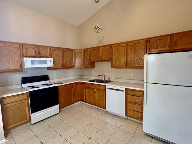 kitchen featuring white appliances, sink, high vaulted ceiling, and light tile patterned floors