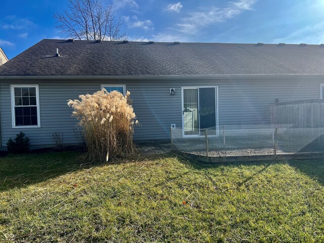 back of property with a patio area and a lawn