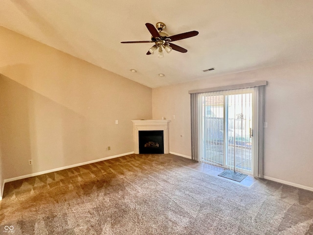 unfurnished living room with ceiling fan and carpet