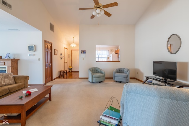 carpeted living room with ceiling fan