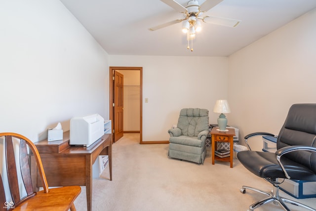 carpeted office space featuring ceiling fan