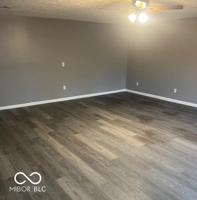 empty room with a textured ceiling, ceiling fan, and dark wood-type flooring