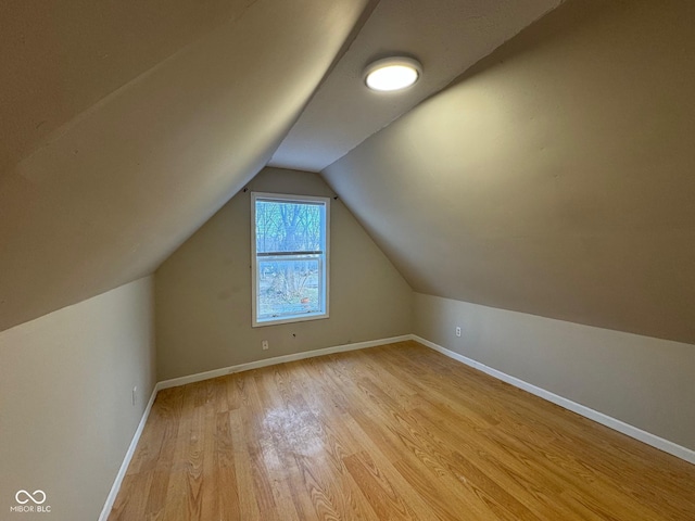 bonus room featuring light hardwood / wood-style flooring and lofted ceiling