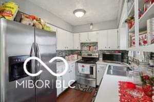 kitchen featuring appliances with stainless steel finishes, dark hardwood / wood-style flooring, white cabinetry, and sink