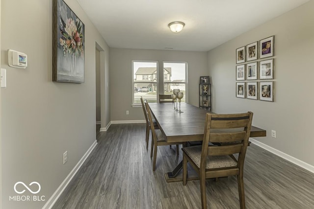 dining area with dark hardwood / wood-style floors