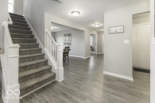 foyer entrance with dark hardwood / wood-style floors