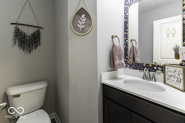 bathroom featuring toilet and vanity