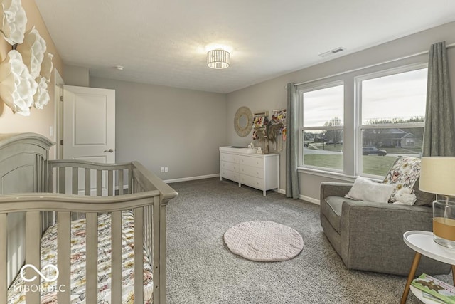 bedroom featuring carpet and a nursery area