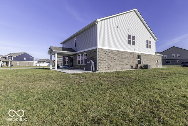 rear view of house featuring central AC unit, a lawn, and a patio