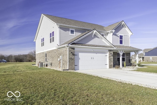 view of front of property featuring a front lawn, cooling unit, and a garage