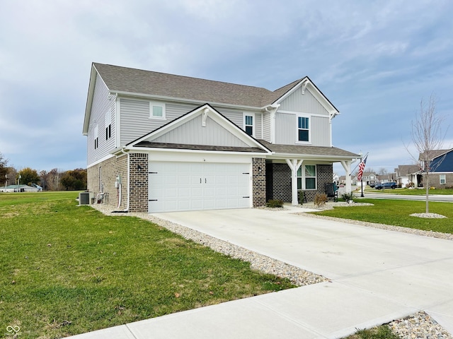 view of front of property featuring a garage, cooling unit, and a front lawn