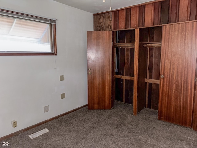 unfurnished bedroom with carpet and a closet