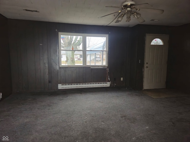 7071 S Charles Pl, Terre Haute, IN 47802 - carpeted entryway with wood walls, ceiling fan, and a baseboard heating unit