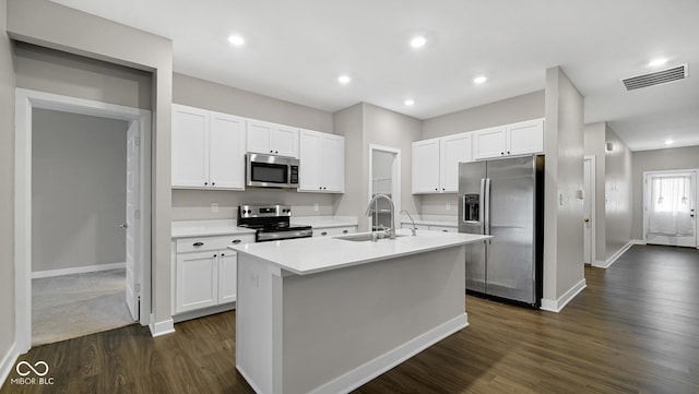 kitchen featuring sink, stainless steel appliances, dark wood-type flooring, an island with sink, and white cabinets