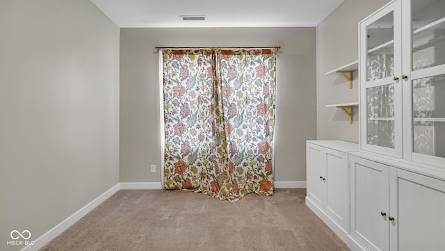 unfurnished room with light colored carpet