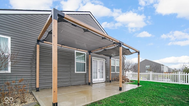 back of property featuring a yard, a patio, and french doors