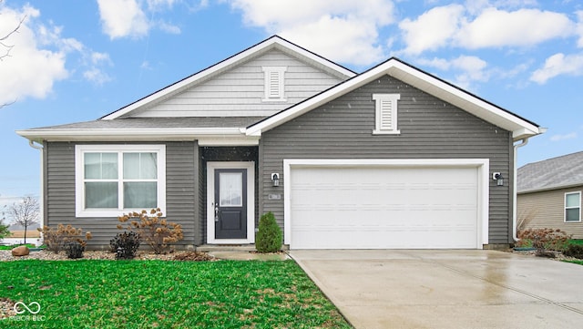 view of front of property featuring a garage and a front lawn